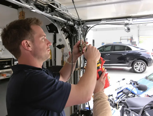 Wickliffe Garage Door Repair safety certified technician performing cable replacement in Wickliffe